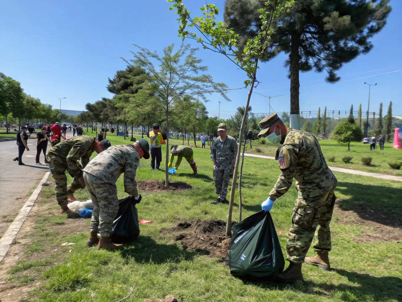 An image of veterans volunteering in a community service project, such as cleaning up a local park or helping at a food bank.
